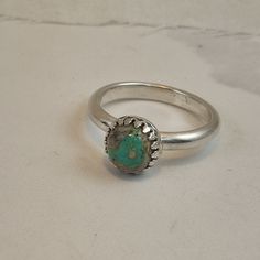 I've mounted this turquoise cabochon in an ornate decorative bezel on  a D-section sterling silver ring, UK size R. The flat side of the D goes against your skin for comfort, while the round side gives it depth and good looks. See pics for international size equivalents Classic Hallmarked Round Turquoise Ring, Classic Turquoise Cabochon Ring For Anniversary, Luxury Turquoise Ring With Stone Setting For Anniversary, Anniversary Turquoise Ring With Stone Setting, Silver Turquoise Ring Hallmarked, Silver Emerald Ring With Bezel Setting, Classic Adjustable Turquoise Ring In Sterling Silver, Silver Turquoise Ring With Bezel Setting, Silver-setting Turquoise Cabochon Ring