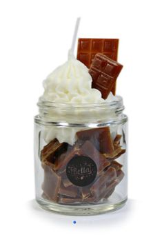 a glass jar filled with assorted chocolates and marshmallows