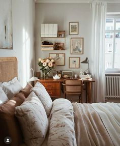 a bed sitting in a bedroom next to a desk with a lamp on top of it