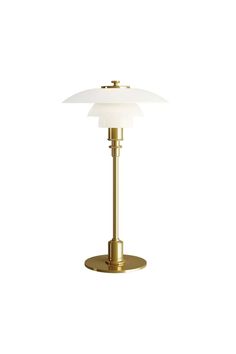 a brass table lamp on a white background