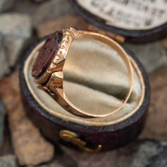 This antique ring features a fancy bezel set tigers-eye cameo with the monogram "MBG" on the underside of the ring. It is tests 10k yellow gold and is currently a size 6.5. Classic Brown Signet Ring, Victorian Gold Signet Ring With Cabochon, Gold Cameo Signet Ring Collectible, Antique Intaglio Signet Ring Collectible, Gold Signet Ring With Cameo Collectible, Victorian 14k Gold Intaglio Engraved Ring, Antique Oval Cabochon Ring With Bezel Setting, Antique Bezel Set Oval Cabochon Ring, Antique Collectible Round Signet Ring