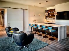 a living room filled with furniture and a flat screen tv mounted to the side of a wall