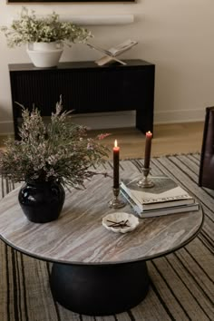 a coffee table with two candles on it