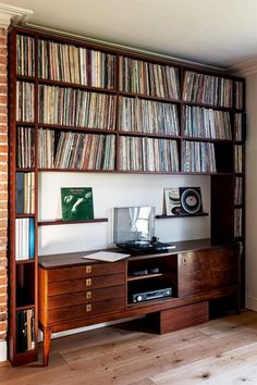 there is a record player on the shelf in this room