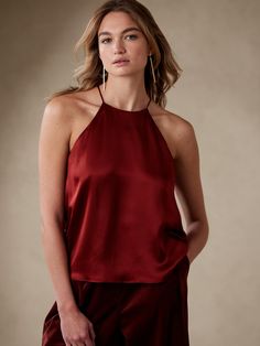 A freeing shape for luxury, this charming halter tank top is meticulously crafted from our beautiful silk charmeuse, a beloved fabric for its lightweight and fluidlike appearance.  RELAXED FIT: Expertly cut for a loose fit.  Halter neck with keyhole Silk Sleeveless Halter Top For Night Out, Silk Halter Neck Top For Night Out, Silk Halter Top For Date Night, Chic Silk Halter Top For Date Night, Sleeveless Silk Halter Top, Elegant Evening Halter Camisole Top, Elegant Evening Halter Tank Top, Elegant Camisole Halter Top For Evening, Elegant Silk Halter Top For Date Night