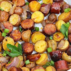 roasted potatoes and onions with parsley in a white bowl