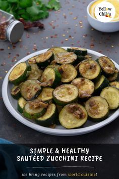 a plate full of sliced zucchini sitting on a table next to other food