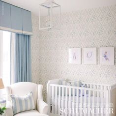 a baby's room with blue and white wallpaper