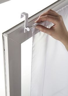 a person is opening the curtain with their hand and pulling it out from behind them