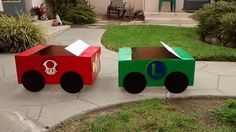 two cardboard train cars sitting on top of a sidewalk