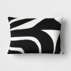 a black and white pillow sitting on top of a wall