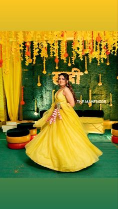 a woman in a yellow dress is posing for the camera