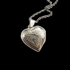 "PAJ engraved sterling silver heart locket on silver chain. Space for two photos. Circa 1960's. Marked \"PAJ Ster\". The locket is approximately 1.2\" inches long including the bail, and the chain is 20 inches long. The locket is made of frosted sterling silver, and the chain is sterling silver. Both are in very good vintage condition. I also have the same locket available without a chain. A lovely Valentine's Day, Anniversary, Birthday, Mother's Day gift for that special someone. Contact me for combined shipping, or a Canada Post rate." Classic Heart Jewelry For Collectibles, Classic Heart-shaped Collectible Jewelry, Classic Heart Shaped Collectible Jewelry, Classic Engraved Double Heart Jewelry, Classic Double Heart Engraved Jewelry, Vintage Double Heart Personalized Jewelry, Silver Etched Heart Pendant Jewelry, Personalized Vintage Double Heart Jewelry, Vintage White Gold Jewelry With Heart Charm