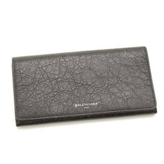 This classic Balenciaga wallet is meticulously crafted of pebbled grey calfskin leather with a Balenciaga logo on the front face. The interior is made with the same leather and features twelve card slots, two bill slots, and one interior zipper compartment. The sleek and functional design of this wallet works perfectly for everyday use. Model number: 542008 Antracite grey Crinkled leather Balenciaga logo Fold-over flap with snap closure Twelve card slots Two bill slots One interior zipper compar Luxury Leather Trifold Wallet For Evening, Leather Wallet With Embossed Logo For Daily Use, Leather Wallet With Embossed Logo For Everyday Use, Black Leather Wallet With Embossed Logo, Designer Leather Wallet With Embossed Logo, Designer Leather Wallet With Smooth Grain, Luxury Leather Wallet With Grained Texture, Formal Leather Wallets With Embossed Logo, Designer Wallets With Embossed Logo For Business