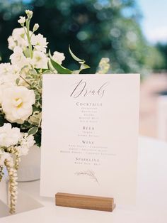 a table with a menu and flowers on it