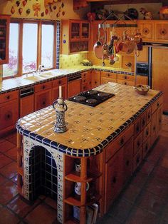 a kitchen with wooden cabinets and tile counter tops