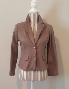 "Vintage Steampunk blazer size large has a steampunk/Victorian style. It is unique and stylish. Laying the garment flat bust measures 38\" waist measures 32\". For a better visual, the mannequin's measurements are bust 34\" waist 25 ½\"." Brown Fitted Blazer For Office, Winter Costume Blazer With Long Sleeves, Fitted Dark Academia Outerwear For Fall, Fall Cosplay Outerwear With Button Closure, Steampunk Costume Outerwear For Fall, Vintage Long Sleeve Cosplay Outerwear, Fall Steampunk Costume Outerwear, Brown Tailored Blazer For Party, Tailored Brown Party Blazer