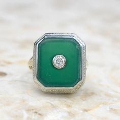 Vintage 14k white gold art deco ring with a green Chrystophrase stone set with a diamond. The top of the ring is white gold, while the gallery is filigreed yellow gold. Era: Art Deco c.192s Markings: 14 Materials: 14k gold, .12 ct diamond, Chrysoprase  Ring Size: 5 (Comes with one free resizing by our jeweler) Face measures 17.25mm x 15.40 mm Weight: 4.7 grams  Condition: Excellent vintage condition with minor surface wear from age. Small chip and light scratching on the Chrysoprase stone. Shipp Gold Art Deco Ring, Chrysoprase Ring, Gold Art Deco, Deco Ring, Gold Art, Art Deco Ring, Stone Settings, Rings Statement, Favorite Jewelry