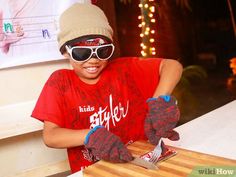 a young boy wearing sunglasses and holding a knife in front of a wooden cutting board