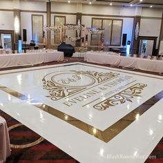 the dance floor is decorated with white and gold decorations