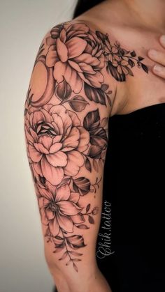 a woman's arm with flowers on it