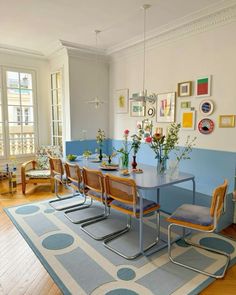 a dining room with blue walls and wooden floors