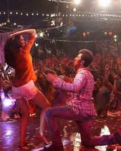 a man and woman dancing in front of a crowd