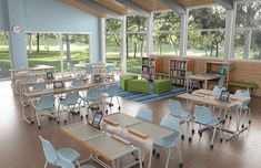 an empty classroom with many desks and chairs in front of large windows that look out onto the field