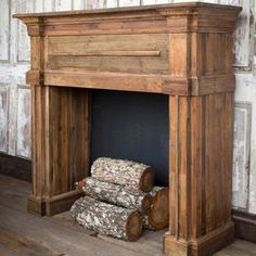 an old fireplace with logs stacked on top