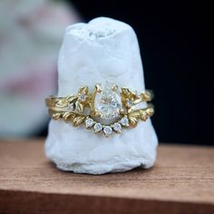 a close up of a ring on top of a piece of white rock with a diamond in the middle