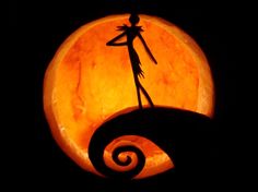 a carved pumpkin with the silhouette of a person on it