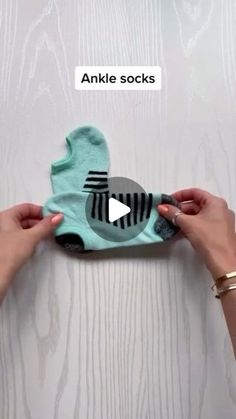 two hands are holding an object that is made out of paper and fabric with the words ankle socks on it