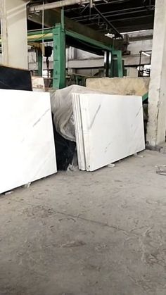 two white refrigerators sitting next to each other in a room with no one around them