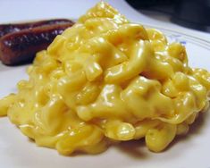 macaroni and cheese on a plate next to a hot dog