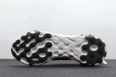 a close up view of the sole of a sneaker with black and white dots