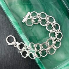 Handmade chain bracelet of heavy round links that are double connected. Sterling silver bracelet closes with a lobster clasp. These link chain bracelets fall gracefully around the wrist and hand in sterling silver. Link bracelets also make a great gift for a friend or family member. Size: Length is 7 1/2" and Width is 1". Weight 37.7 grams or 1.33 oz Bracelet Sizing: A good guide for your correct bracelet length is 1/2" longer than a tight wrist measurement. Use a flexible tape measure or strip of paper, then measure the paper strip with ruler. Composition: Handmade and one of a kind in nickel free sterling silver. Processing Time: Usually I can ship the item out within 2 days from the order date unless there is a back order. Back orders will be shipped within 2 weeks of the order date. SH Modern Sterling Silver Bracelets With Rolo Chain, Silver Sterling Silver Chain Link Charm Bracelet, Silver Link Bracelets With Rolo Chain, Modern Silver Rolo Chain Bracelet, Sterling Silver Jubilee Charm Bracelet, Nickel-free Sterling Silver Chain Link Bracelet, Sterling Silver Rolo Chain Bracelet, Silver Chain Link Bracelet With Lobster Clasp, Silver Chain Bracelet With Lobster Clasp