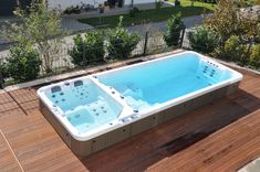 a hot tub sitting on top of a wooden deck