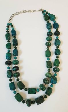 Substantial handmade stone necklace in beautiful turquoise/green with easy hook clasp. Hangs in double loop at length of approximately 10 inches on simple chain. Cannot confirm if natural stone is african turquoise, type of jade, adventurine, or other. Has a matte finish, not shiny. Green Chrysocolla Single Strand Necklace, Green Chrysocolla Round Bead Necklaces, Green Chrysocolla Round Beads Necklace, Turquoise Necklace For Jewelry Making With Chrysocolla, Chrysocolla Turquoise Necklace For Jewelry Making, Handmade Green Turquoise (amazonite) Necklace, Handmade Green Turquoise Necklace In Amazonite, Green Chrysocolla Necklaces With Natural Stones, Turquoise Beaded Jade Necklace