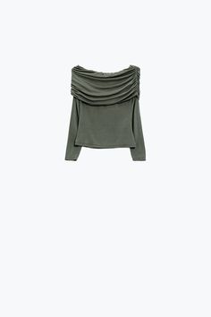 Step into spring with our trendy Bodycon Off Shoulder Top in Green Khaki. This top is designed to accentuate your figure with its bodycon fit, while the off-the-shoulder boat neckline adds a touch of romantic allure. Made from a blend of 95% viscose and 5% elastane, it offers a comfortable stretch and a lightweight feel, perfect for those warmer days. The ruched details add a stylish twist, making this top a must-have for any fashion-forward wardrobe. Model Info: Model is wearing size S. Model's