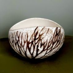 a white and brown bowl sitting on top of a table