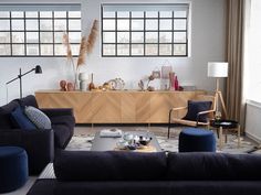 a living room with two couches and a coffee table in front of a window