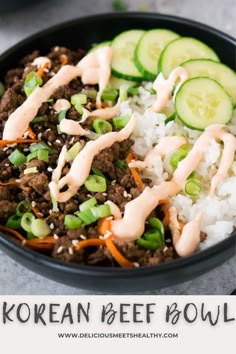 korean beef bowl with rice and cucumbers in a black bowl