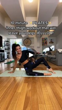 a woman is doing yoga in the middle of a living room with her legs spread out