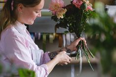 a woman florists flowers from her bouquet