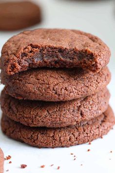 chocolate cookies stacked on top of each other with one cookie in the middle and another behind them