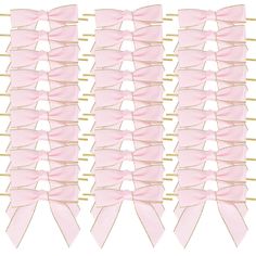 pink bows with gold pins are lined up on a white background and placed in rows