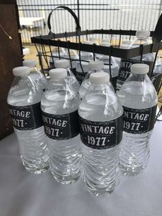 six bottled water bottles sitting on top of a table