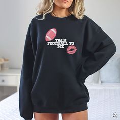 Calling all football fans! This comfy sweatshirt is the ultimate way to show your love for the game on game day or any day. Whether you're a cheering on your favorite team, a dedicated football mom, or a football enthusiast, this sweatshirt is for you! This design is perfect for: *Football Moms: Show your team spirit and celebrate football season in style. *Women Football Fans: Represent your passion for the game in a comfortable and fun way. *Girlfriend Gift: Surprise your football-loving girlf Game Day Fan Apparel Long Sleeve Sweatshirt, Fleece Tops With Letter Print For Fans, Sports Fan Long Sleeve Fleece Sweatshirt, Fleece Long Sleeve Sports Fan Sweatshirt, Game Day Fleece Sweatshirt With Graphic Print, Game Day Football Season Crew Neck Sweatshirt, Football Season Game Day Crew Neck Sweatshirt, Team-colored Long Sleeve Sweatshirt For Football Season, School Spirit Long Sleeve Tops For Football Season