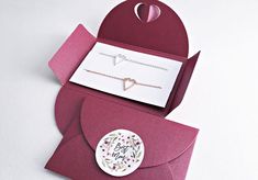 an open card with a heart on it and a button attached to the inside of it