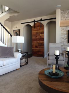 a living room filled with furniture and a wooden door